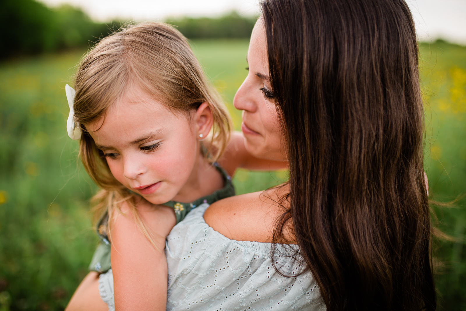  Mother holds daughter in a field, mommy and me session at Shawnee Mission Park, Kansas City family photographer 