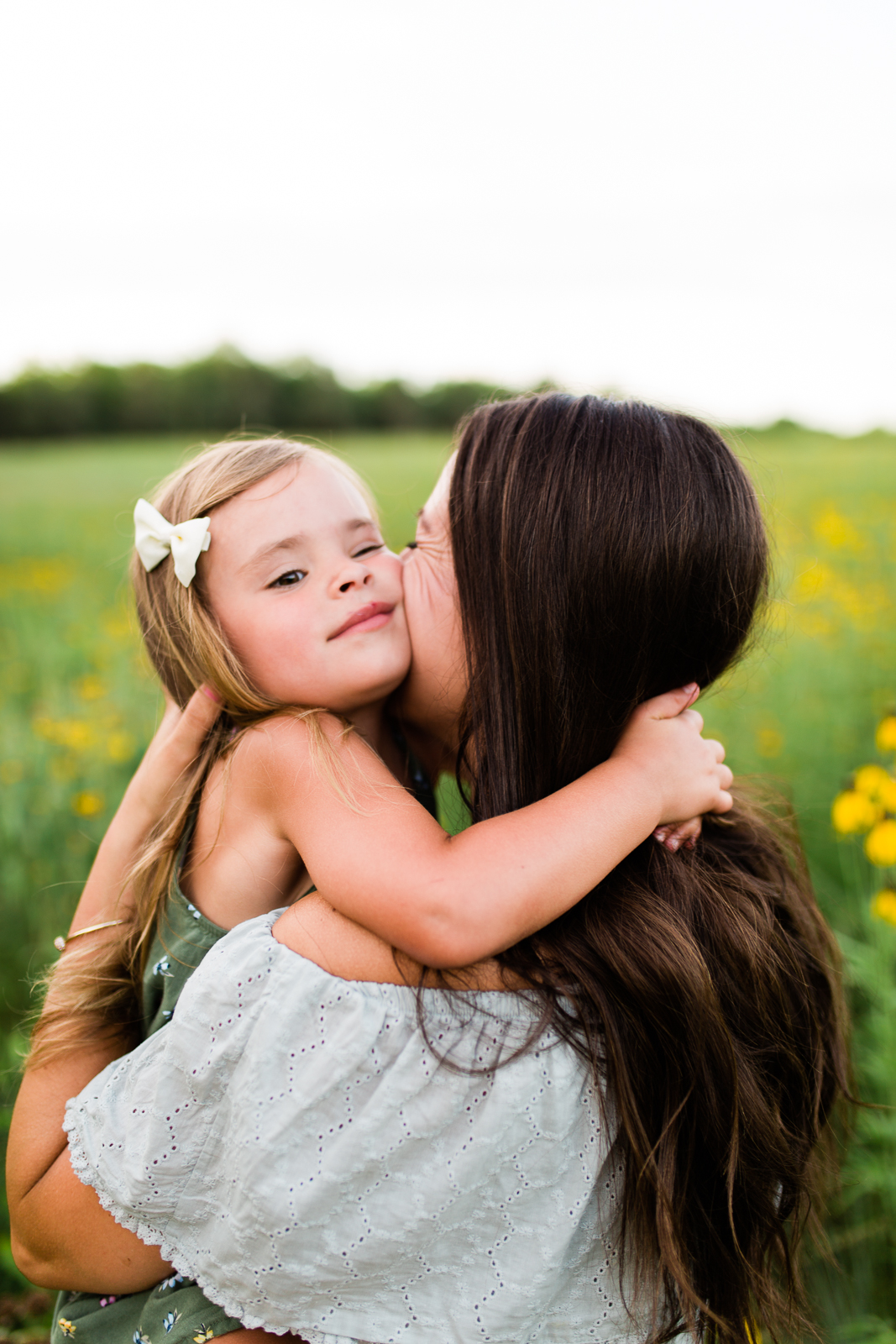  Daughter hugs mother in a field of flowers, mommy and me session at Shawnee Mission Park, Kansas City family photographer 