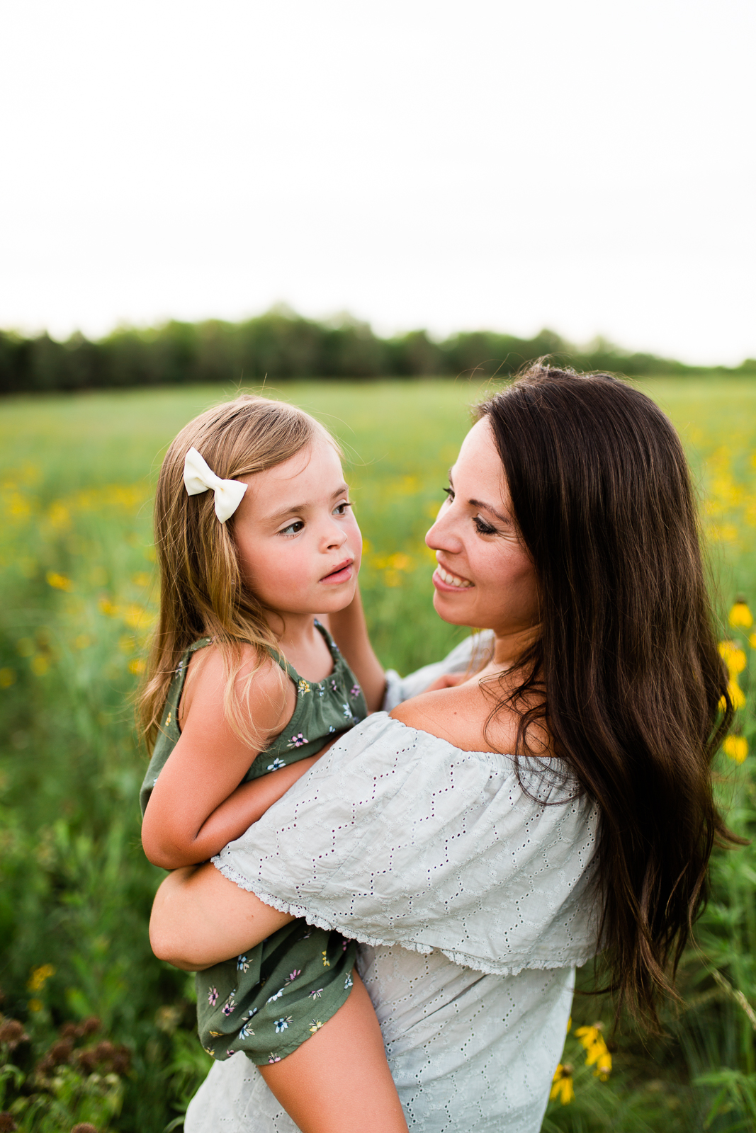  Mother holds daughter in a field, mommy and me session at Shawnee Mission Park, Kansas City lifestyle photographer 