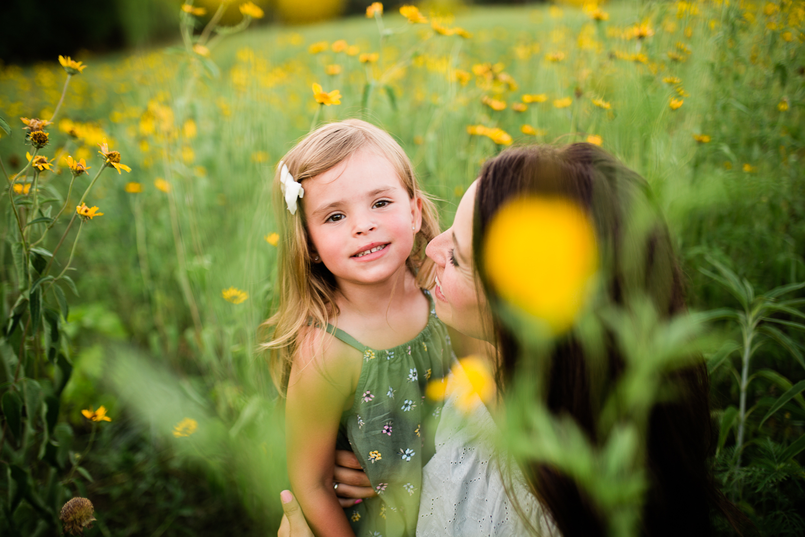  Mother and daughter cuddle in a field of flowers, mommy and me session at Shawnee Mission Park, Kansas City family photographer 