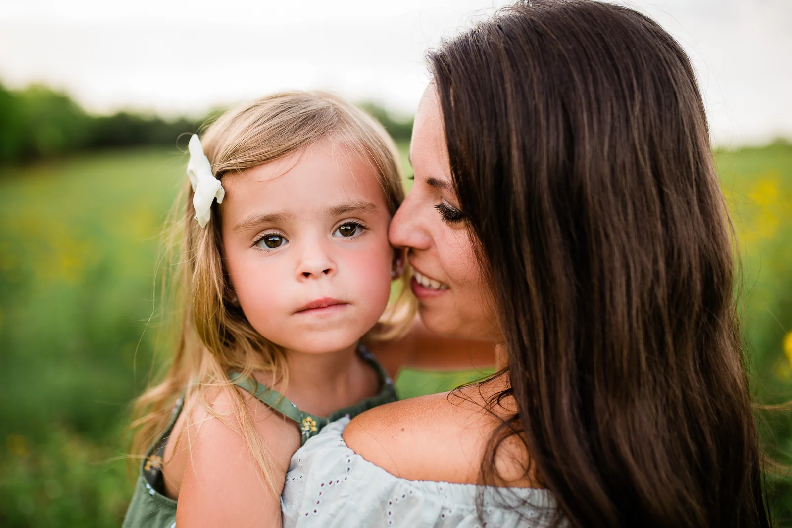 Black and white portrait of mother cuddling with daughter in a field, mommy and me session at Shawnee Mission Park, Kansas City emotive portrait photographer