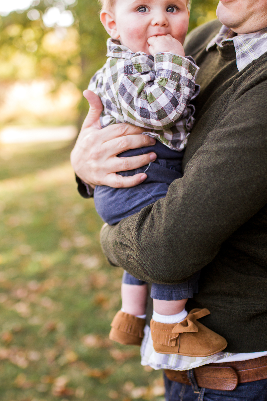  Close up portrait of father holding son in the autumn sunlight, Kansas City candid family photos, Kansas city mini session details 