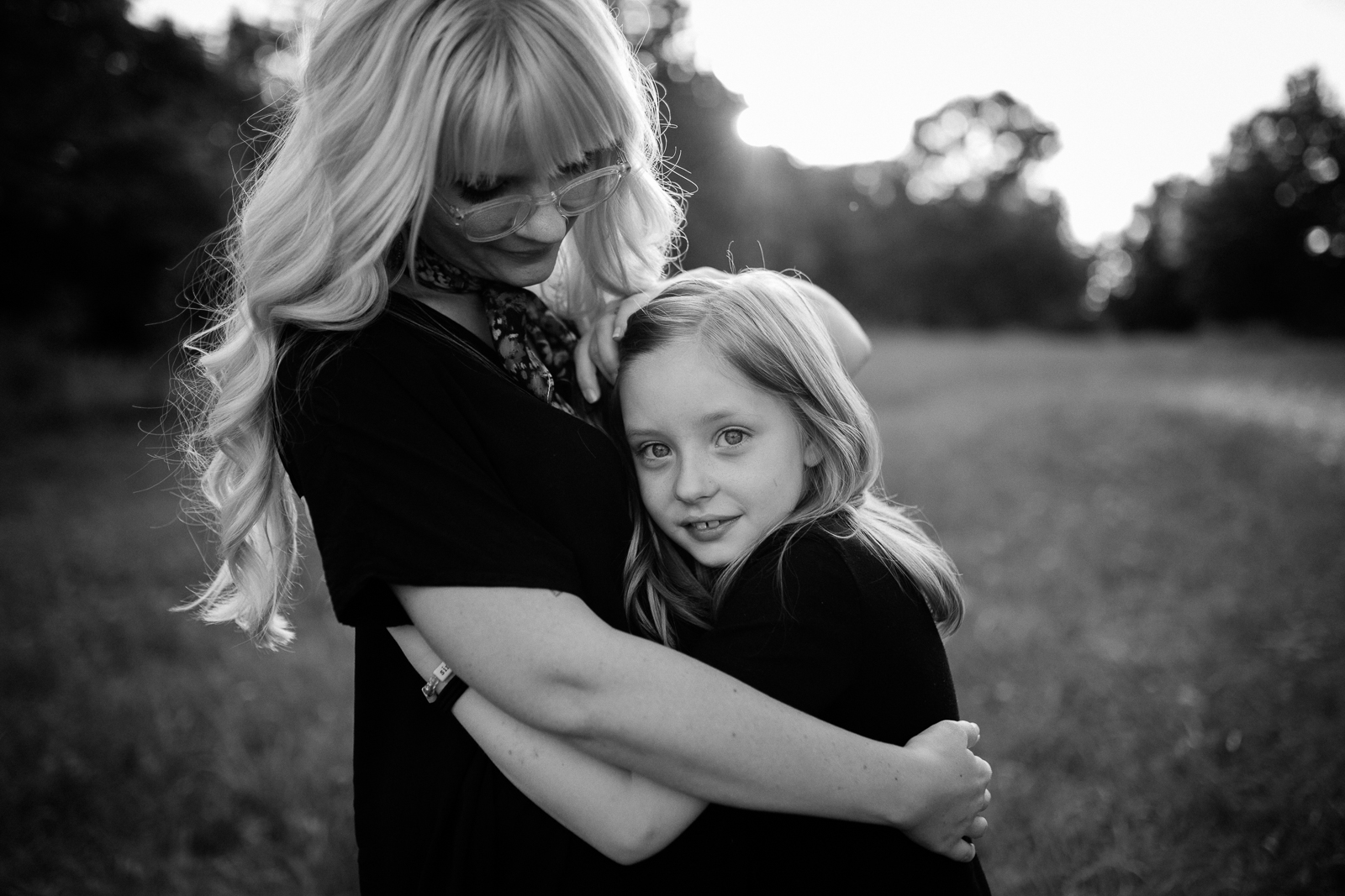  Mother and daughter embrace in the evening light, black and white portrait of mother and daughter, emotive family photos, Lee's Summit family photographer, golden hour session at Lake Jacomo, Rebecca Clair Photography 