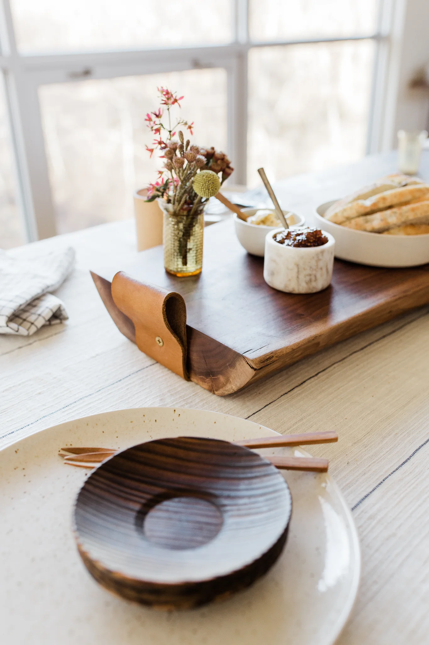 Thick cutting board with leather handle and a vase of flowers, Halo youth cutting board styled session, Kansas City lifestyle product photography, Rebecca Clair Photography
