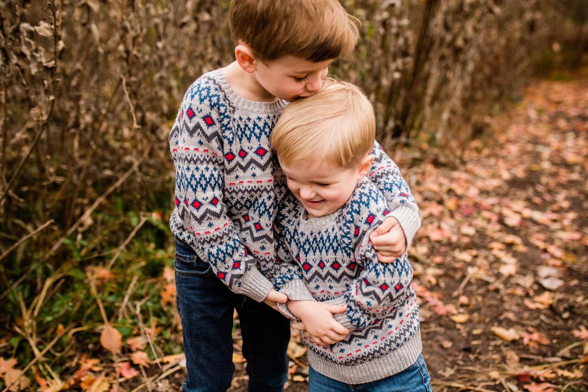 Two brothers in matching sweaters hug, Kansas City family photographer, Rebecca Clair Photography