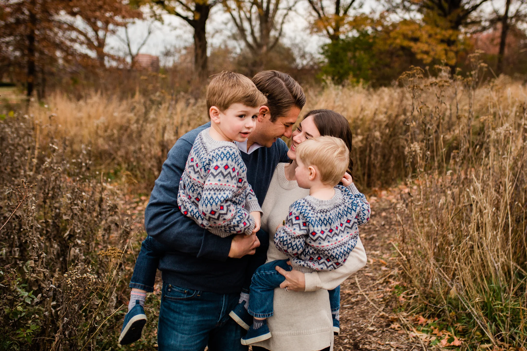  Black and white portrait of family embracing in a field, emotional family portrait, Kansas City candid family photographer, Rebecca Clair Photography 