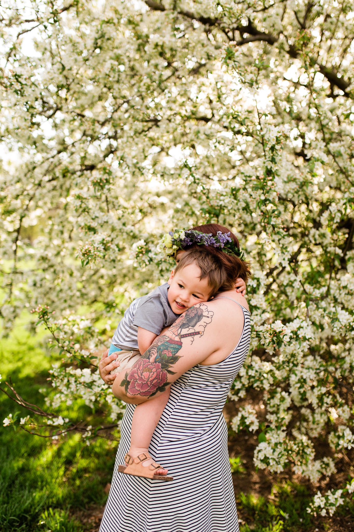  Mother holds her toddler son by the flowering trees, Kansas City spring mini sessions, Loose Park, Rebecca Clair Photography 