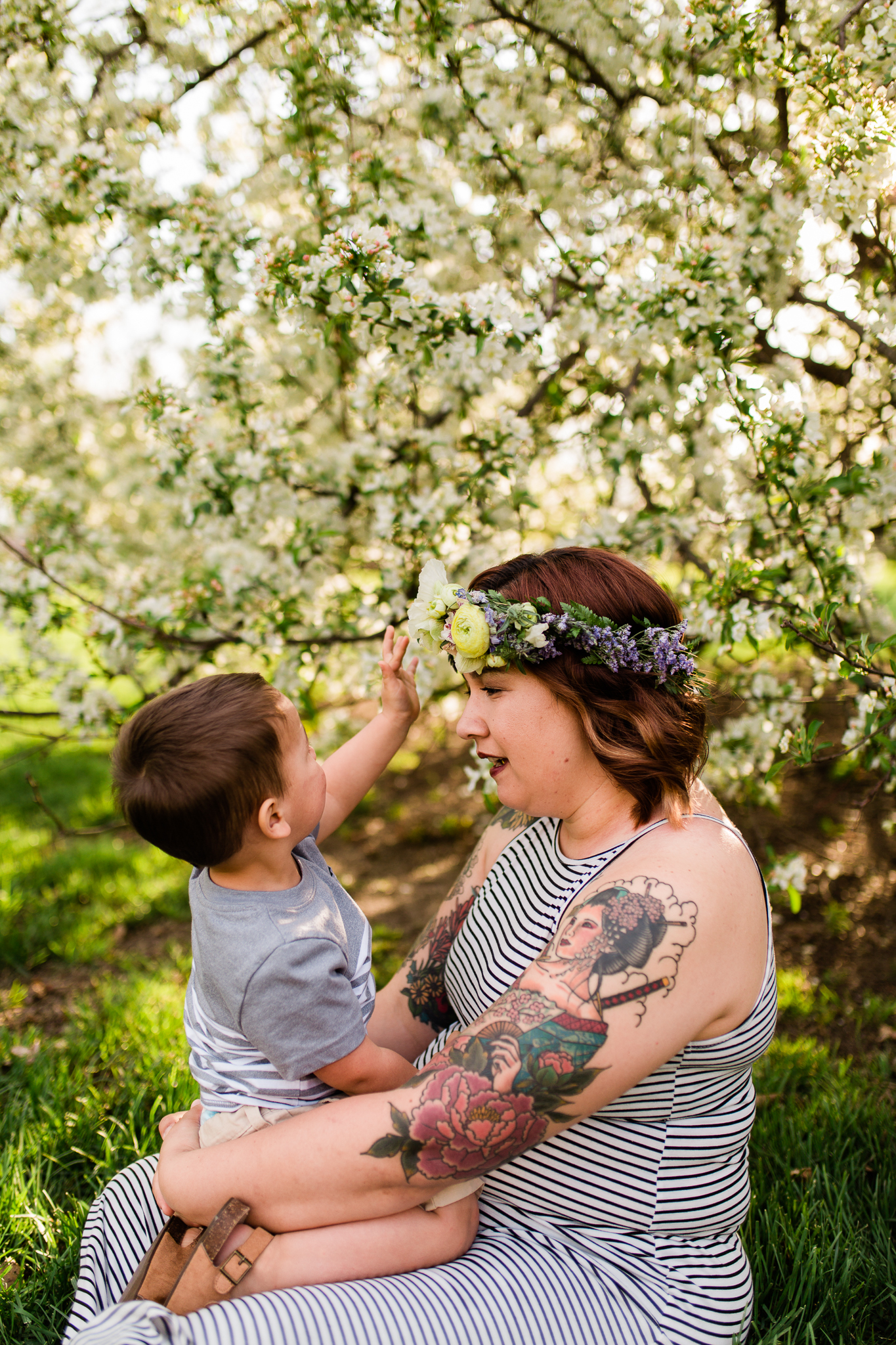  Little boy touches his mother's flower crown, spring mommy and me mini session at Loose Park, Rebecca Clair Photography 