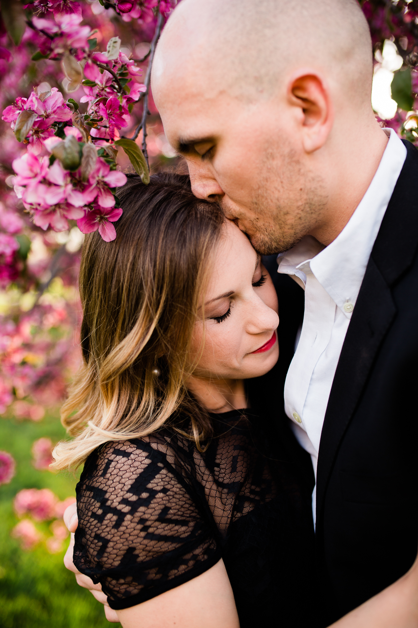  Man kisses his fiance's forehead under the apple blossoms, Kansas City emotive engagment photography, Rebecca Clair Photography 