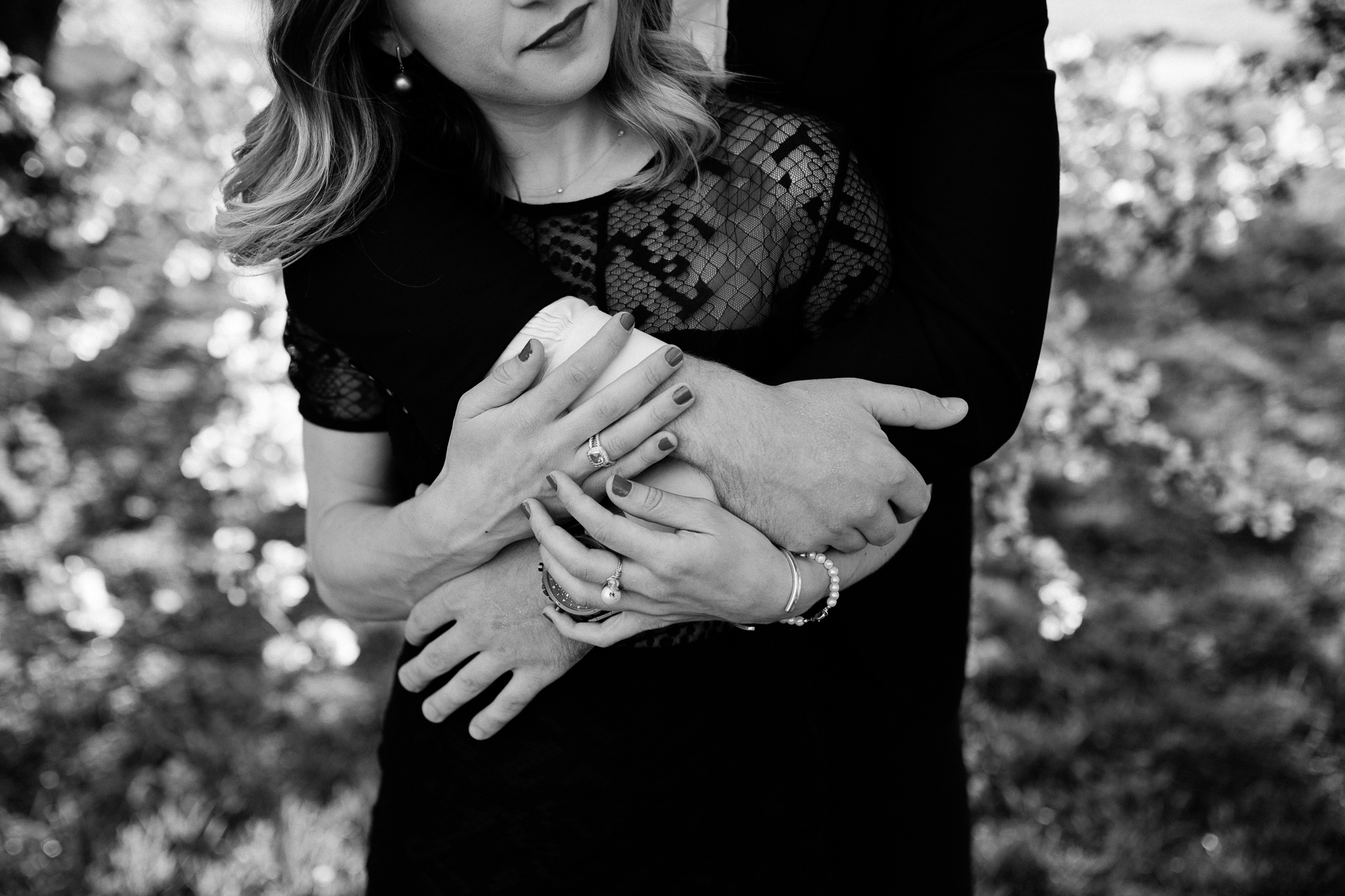  Black and white detail photo of couple embracing, hands together, Kansas City artistic engagement photos, Rebecca Clair Photography 