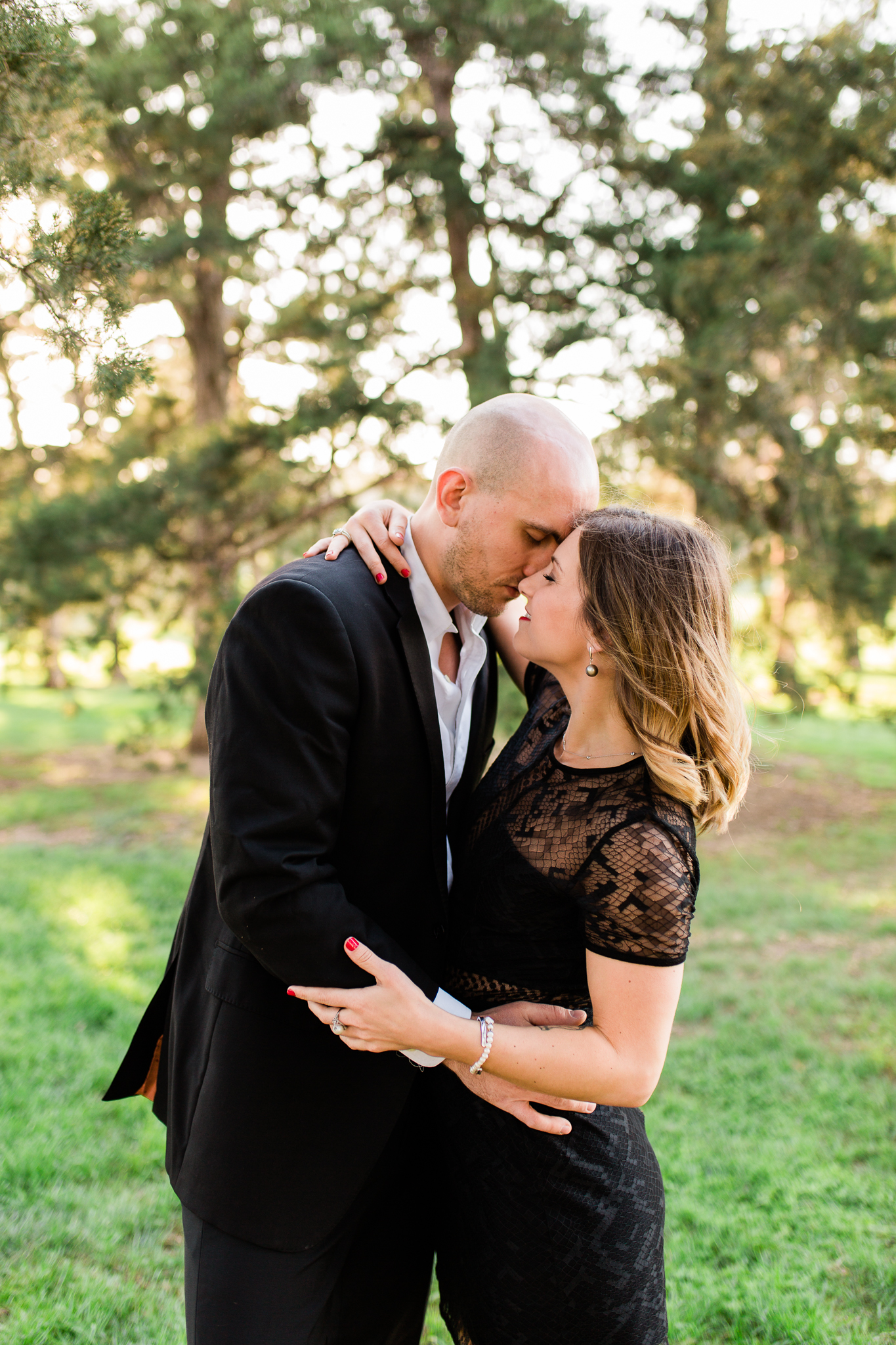 Couple embraces in the golden evening light, Kansas City engagment photographer, Rebecca Clair Photography