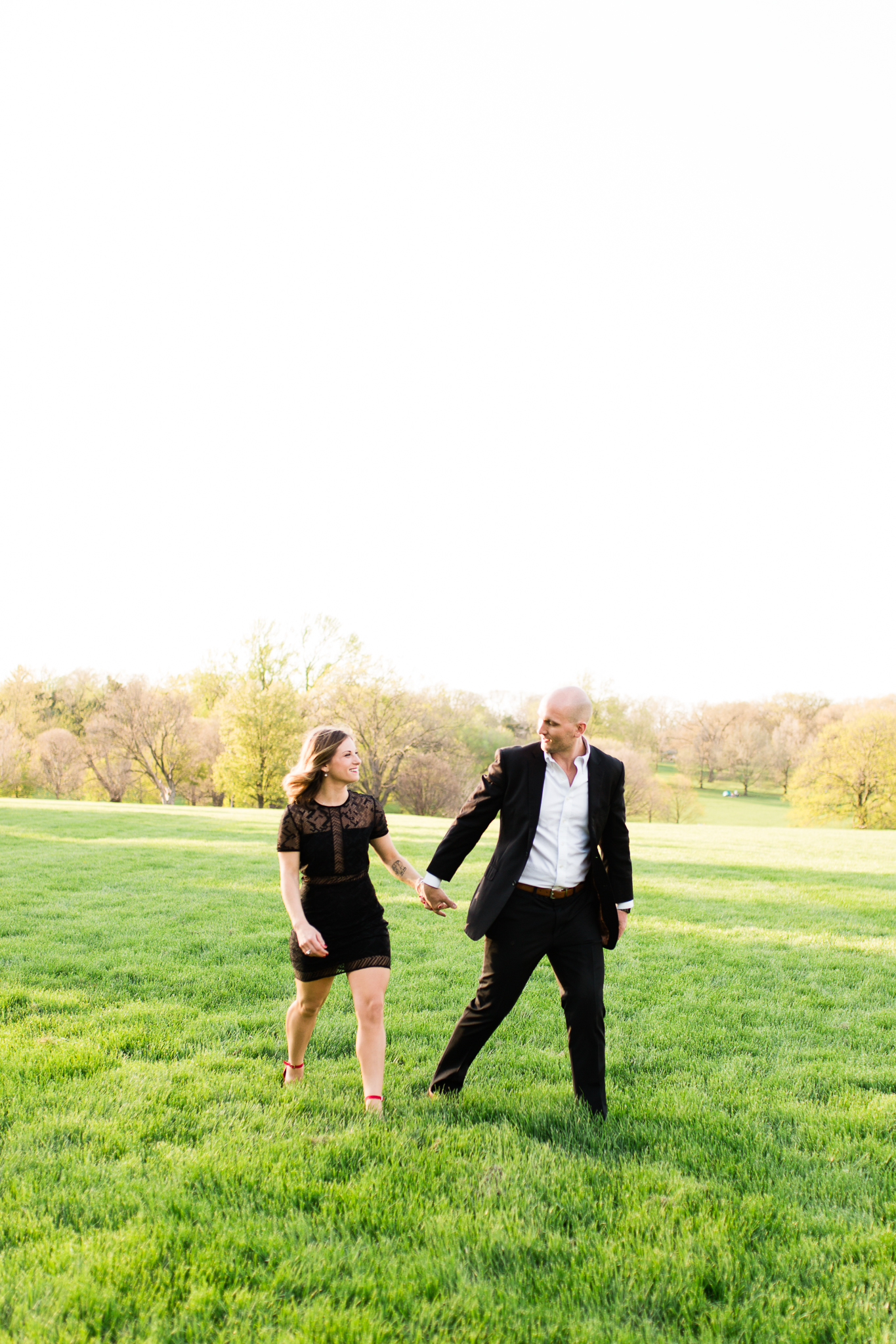  Formal couple walks across an open field, Loose Park couples session, Rebecca Clair Photography 