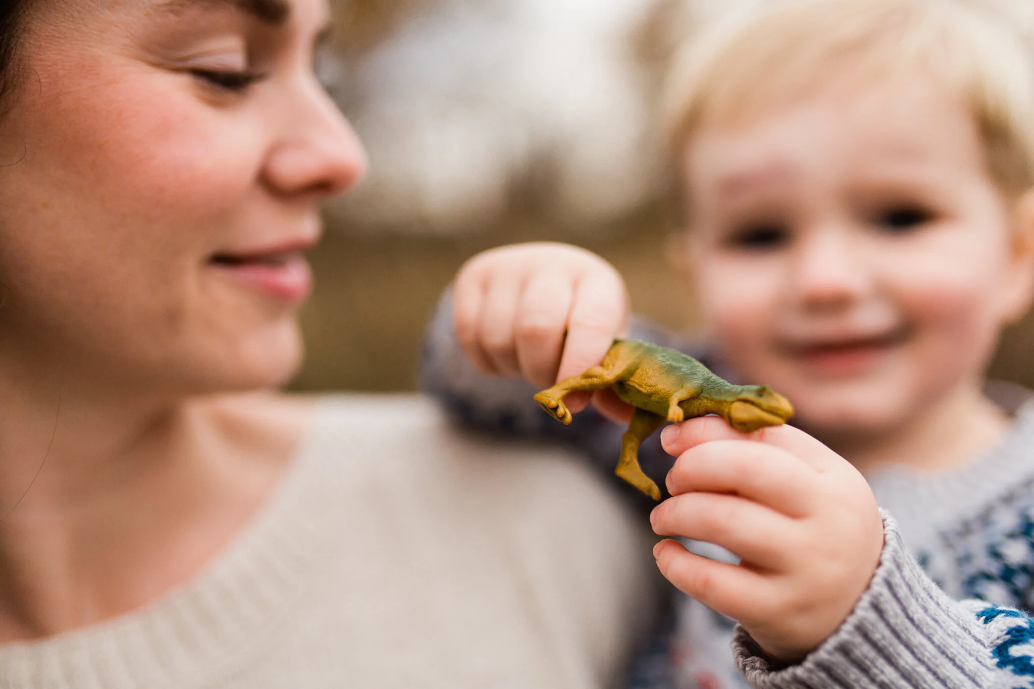 Mother holds her son holding a toy dinosaur, Kansas City real life family photos, Rebecca Clair Photography