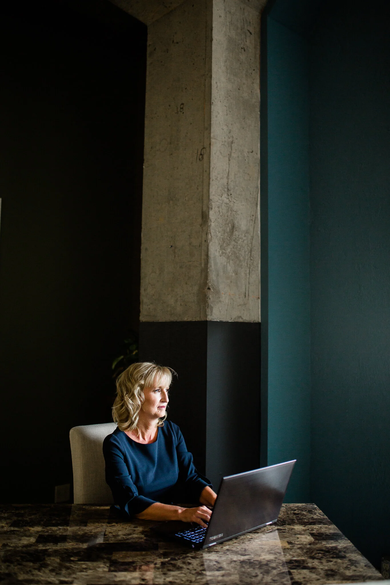 Woman works on the computer in her formal offic, Kansas City branding photographer, Rebecca Clair Photography