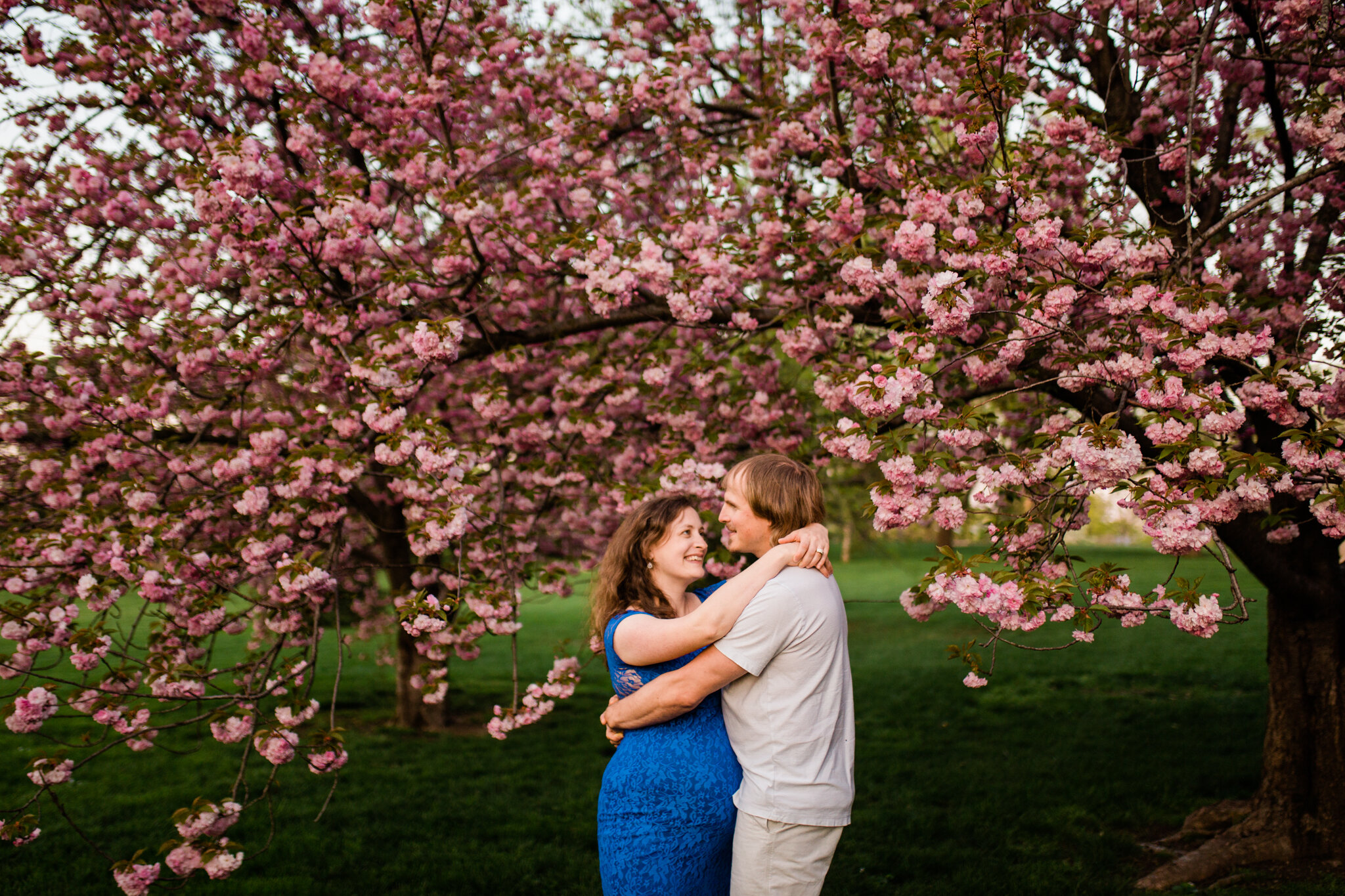  Pregant couple dancing under a flowering cherry tree, Loose Park spring maternity session, Rebecca Clair Photography 