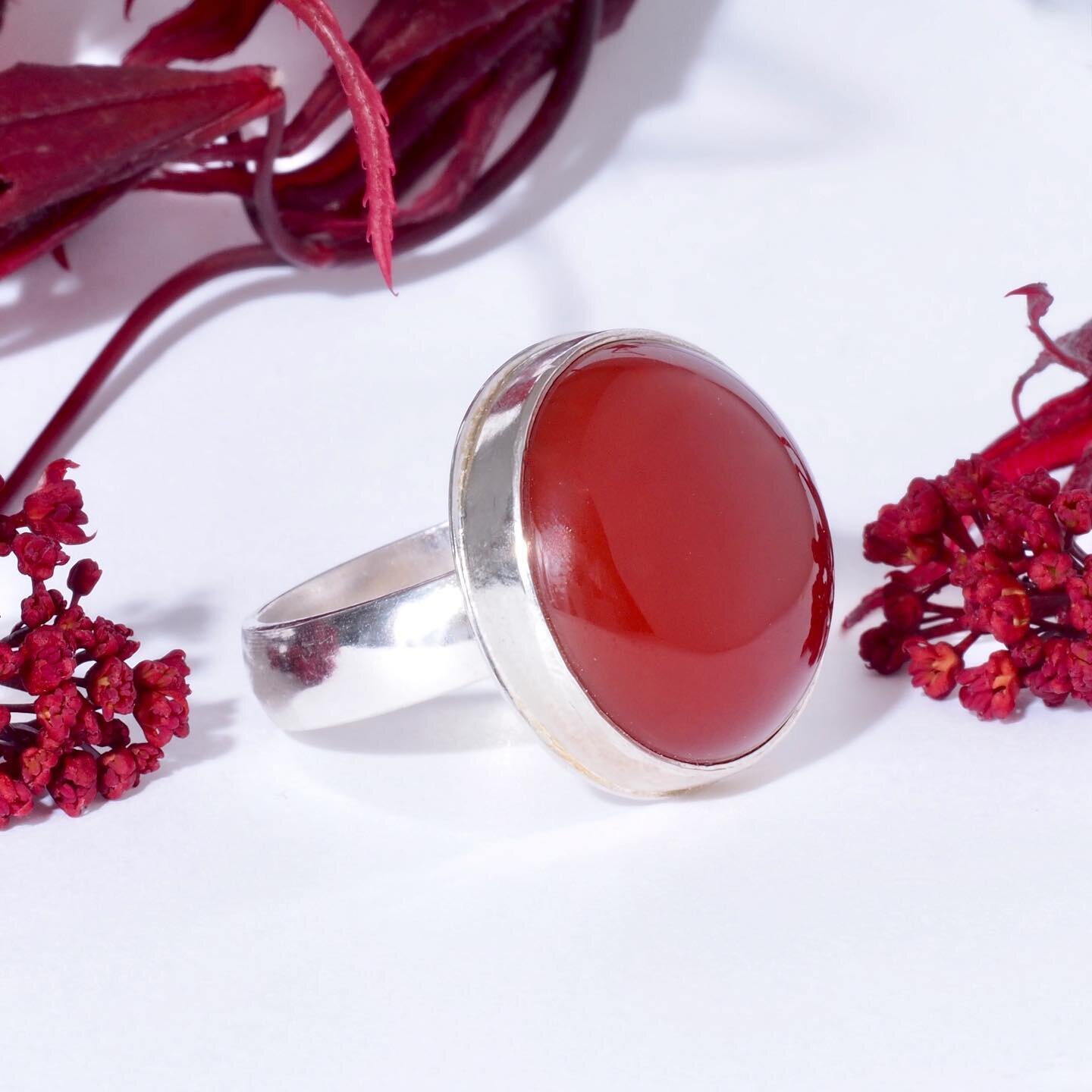 Colors of nature - impressive carnelian cabochon in the same hues as newly emerging leaves and flowers of a red Japanese Maple tree.  This large carnelian is set in shiny recycled sterling silver on a comfort band in size 8 (we can resize it for you 