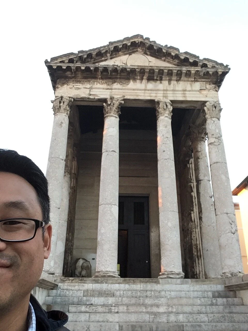 History teacher and professor in front of greek and roman temple