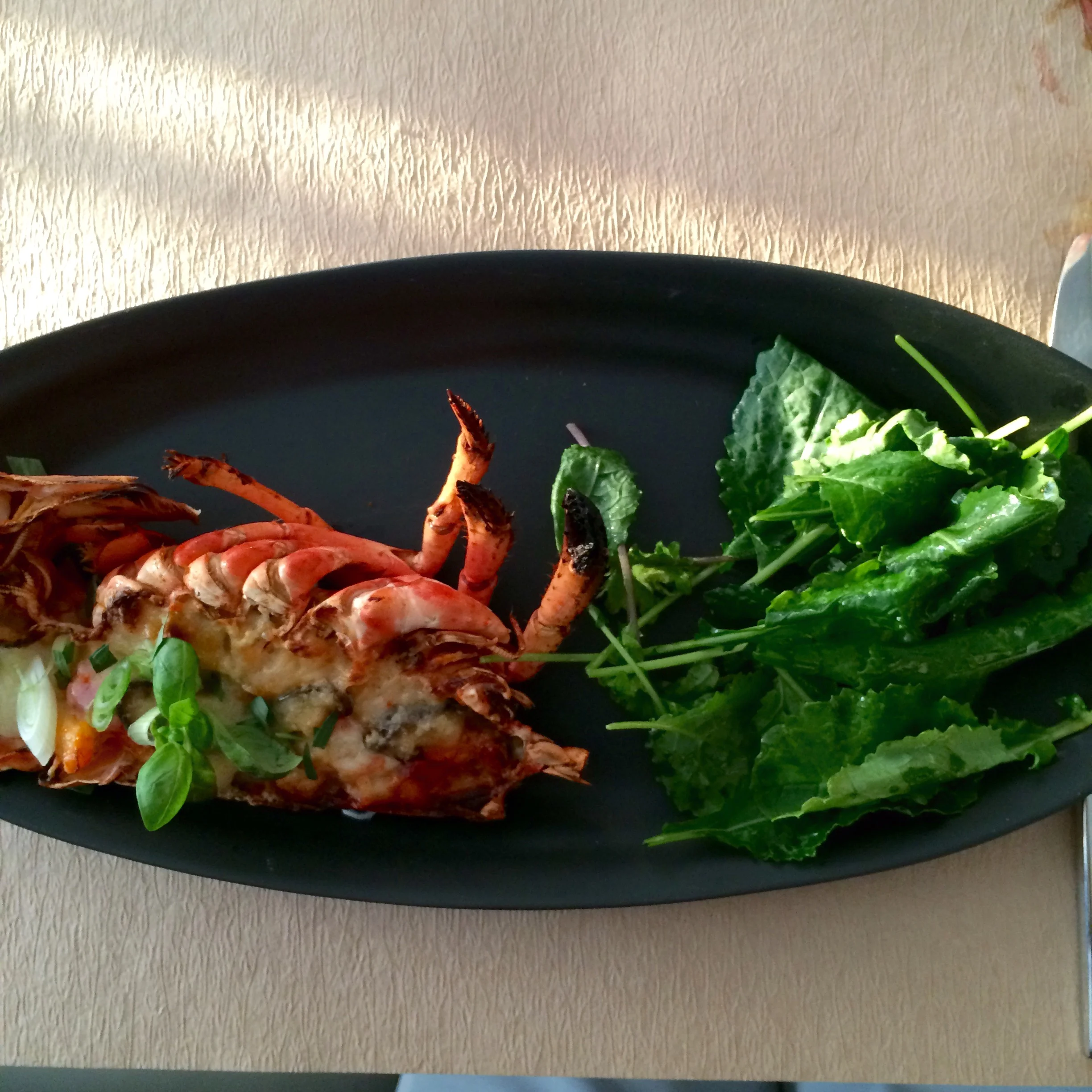 Lobster thermidor with gruyere, shiitake mushrooms, and tarragon served with kale salad
