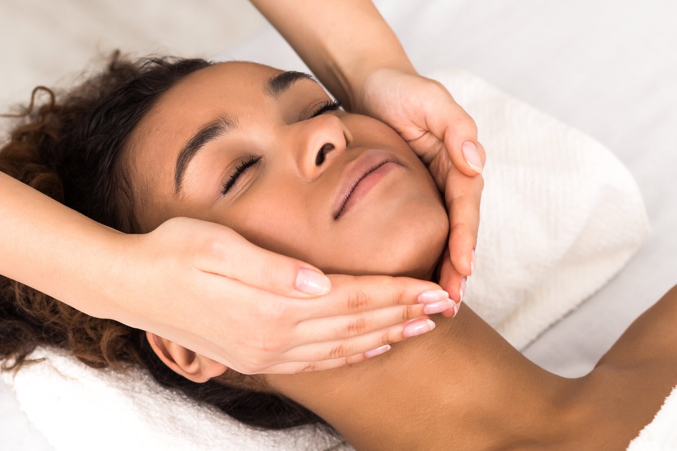 A photo of a female receiving a face massage
