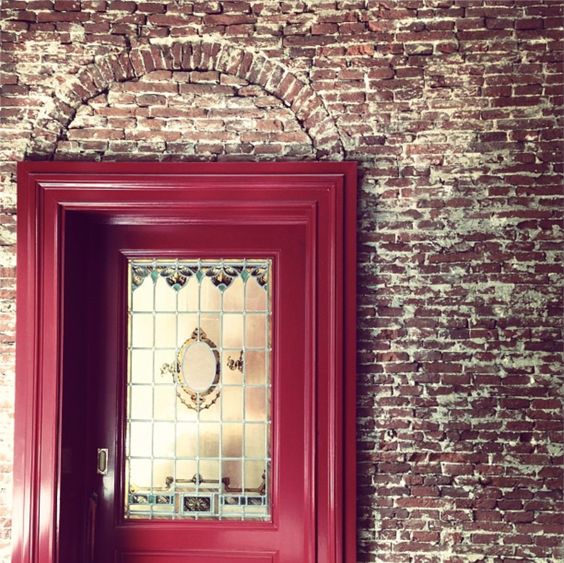 Interior wall with exposed brick, It shows original arch of old opening later patched up and fitted with shorter rectangular door. Amsterdam, Gouden Bocht