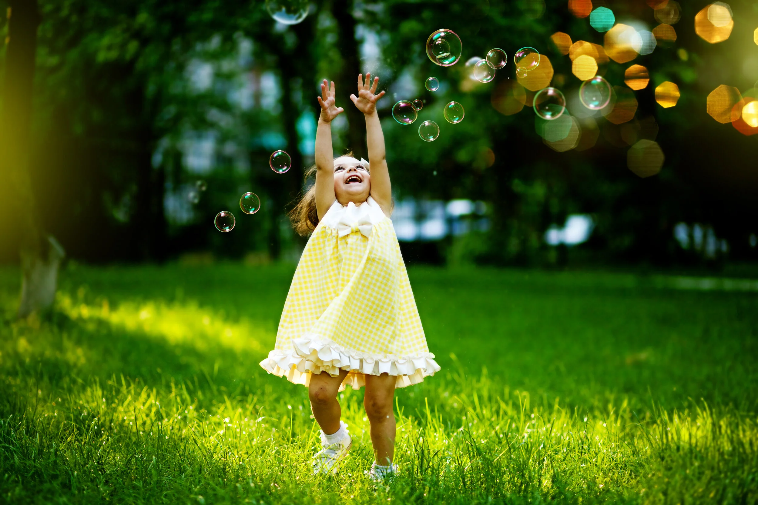 Toddler girl playing with bubbles