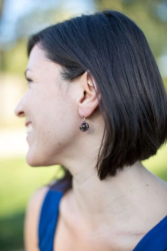 Antiqued copper wrapped wire ball earrings on sterling silver earwires on model