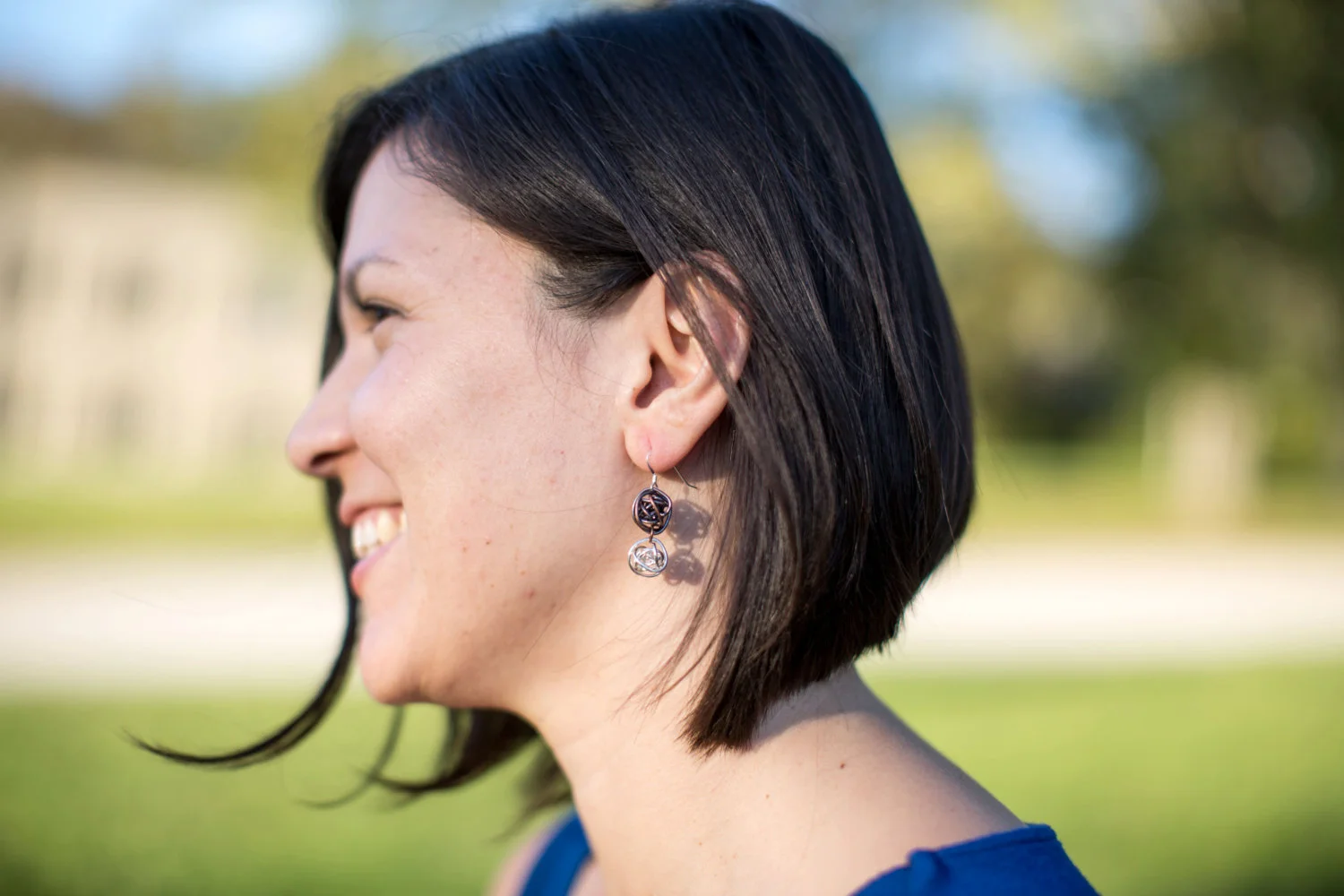 Antiqued copper and bright silver wrapped wire ball earrings on sterling silver earwires on model