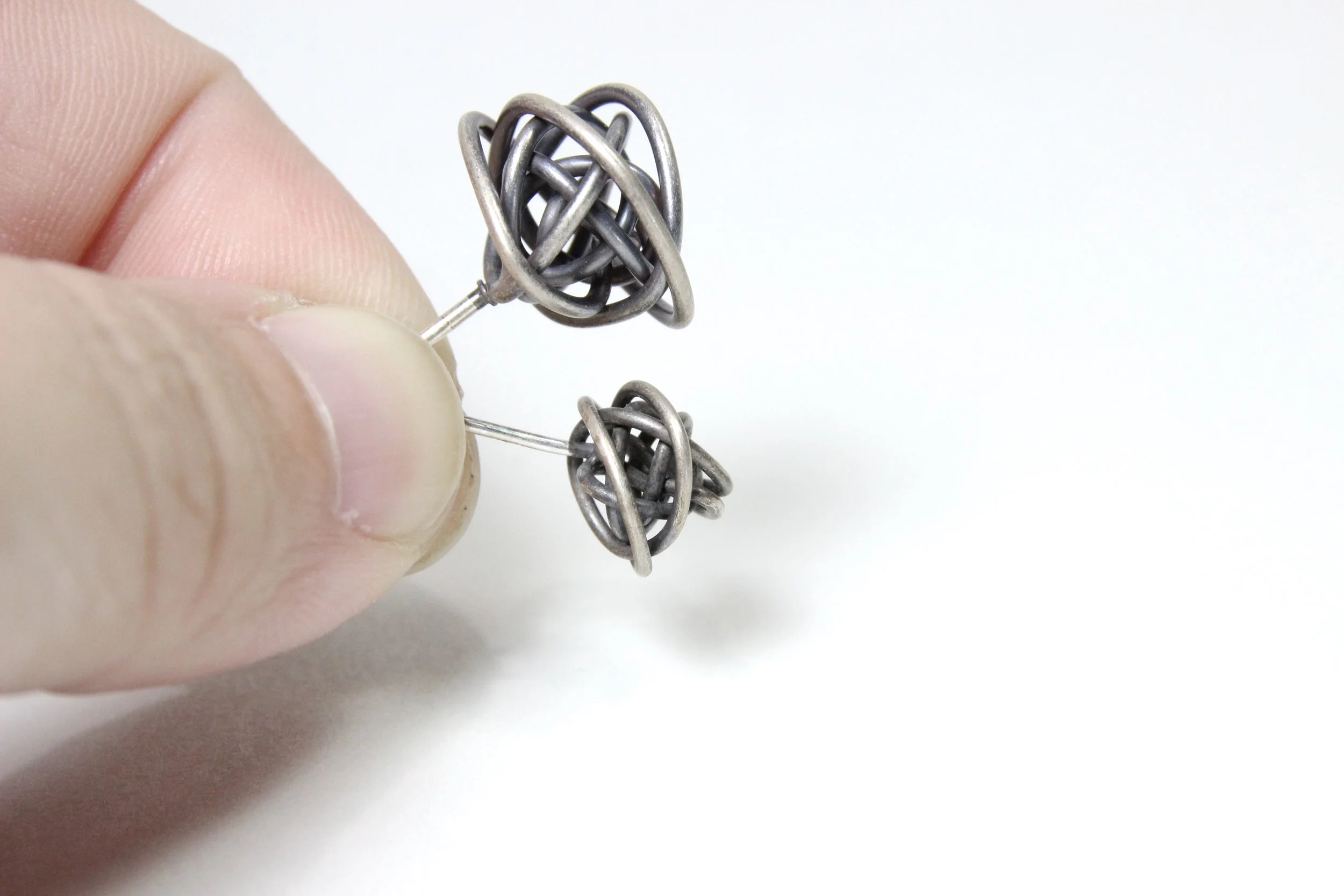 Antique Silver Scribbles and Tiny Scribbles stud earrings in hand