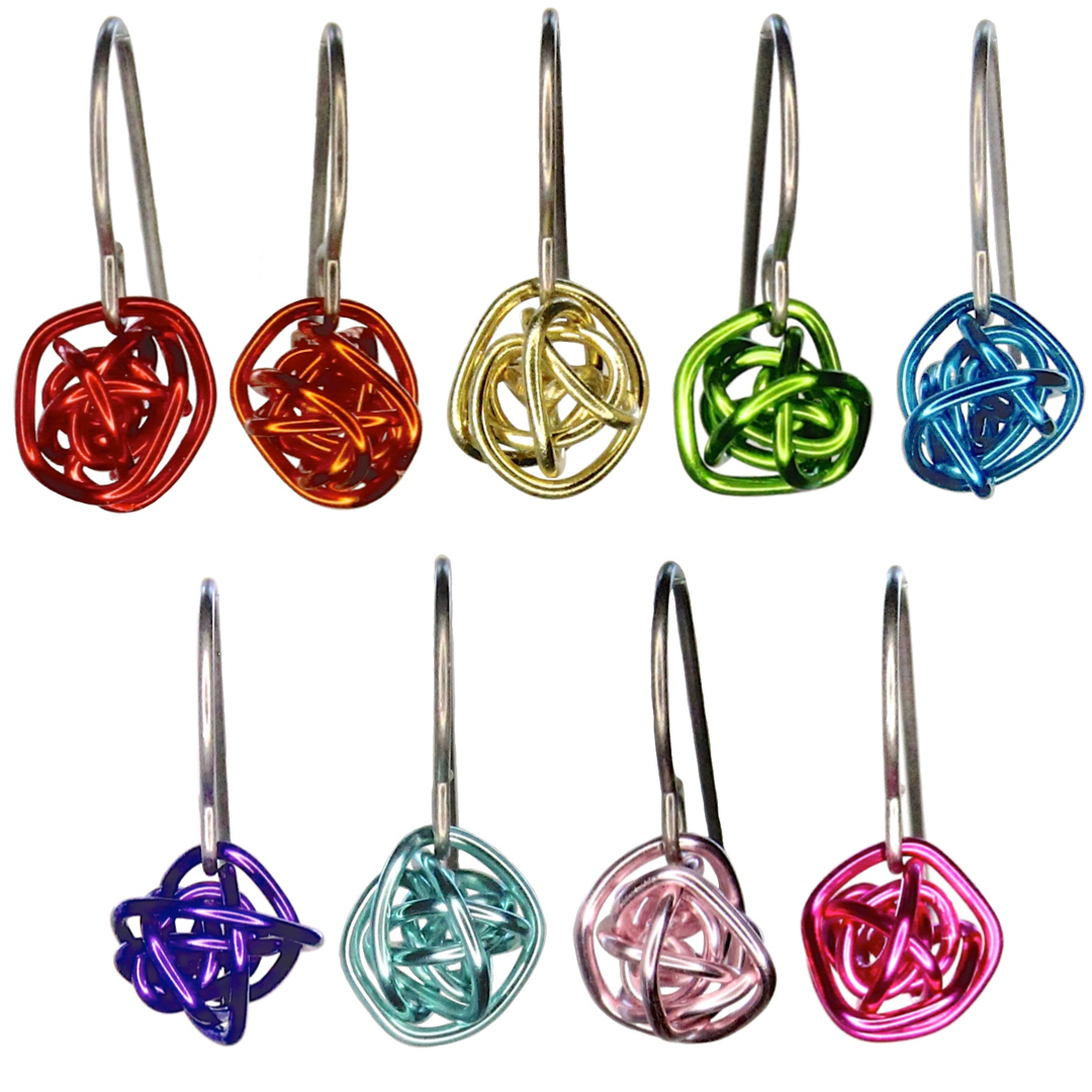 Earrings are colorful wire wrapped loosely into a small ball. All nine color options are shown together. The wire is shiny and smooth. Earring wires are light gray titanium french hooks.