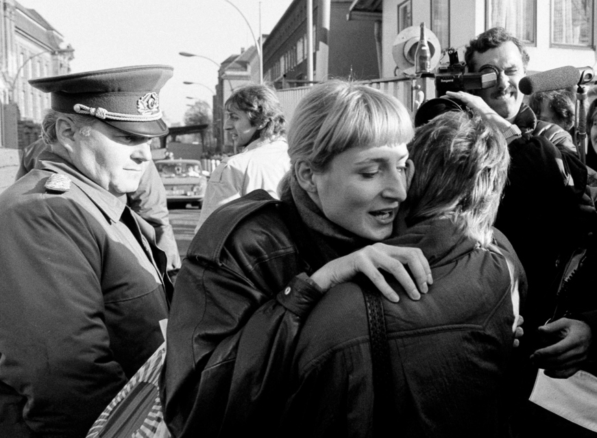 An East German woman embraces a West German woman at the Invalidenstrasse border checkpoint after the opening of the Berlin Wall was announced, Nov. 10th, 1989 . Source: REUTERS