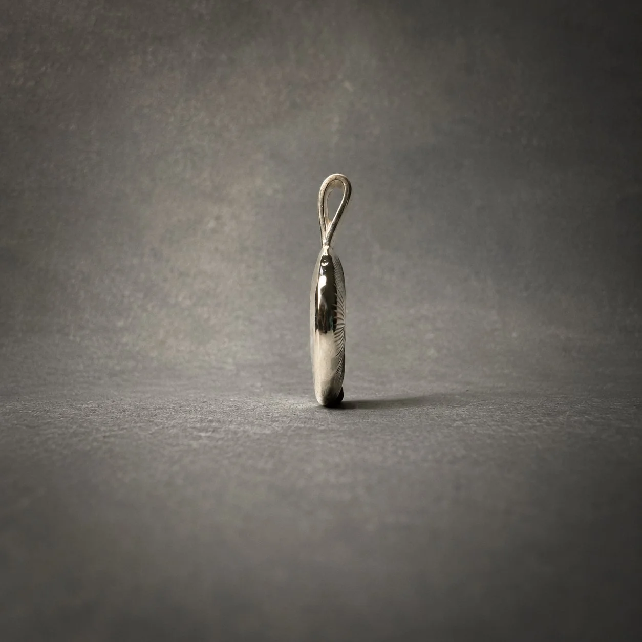 Gills silver pendant, side view showing organic curved shape