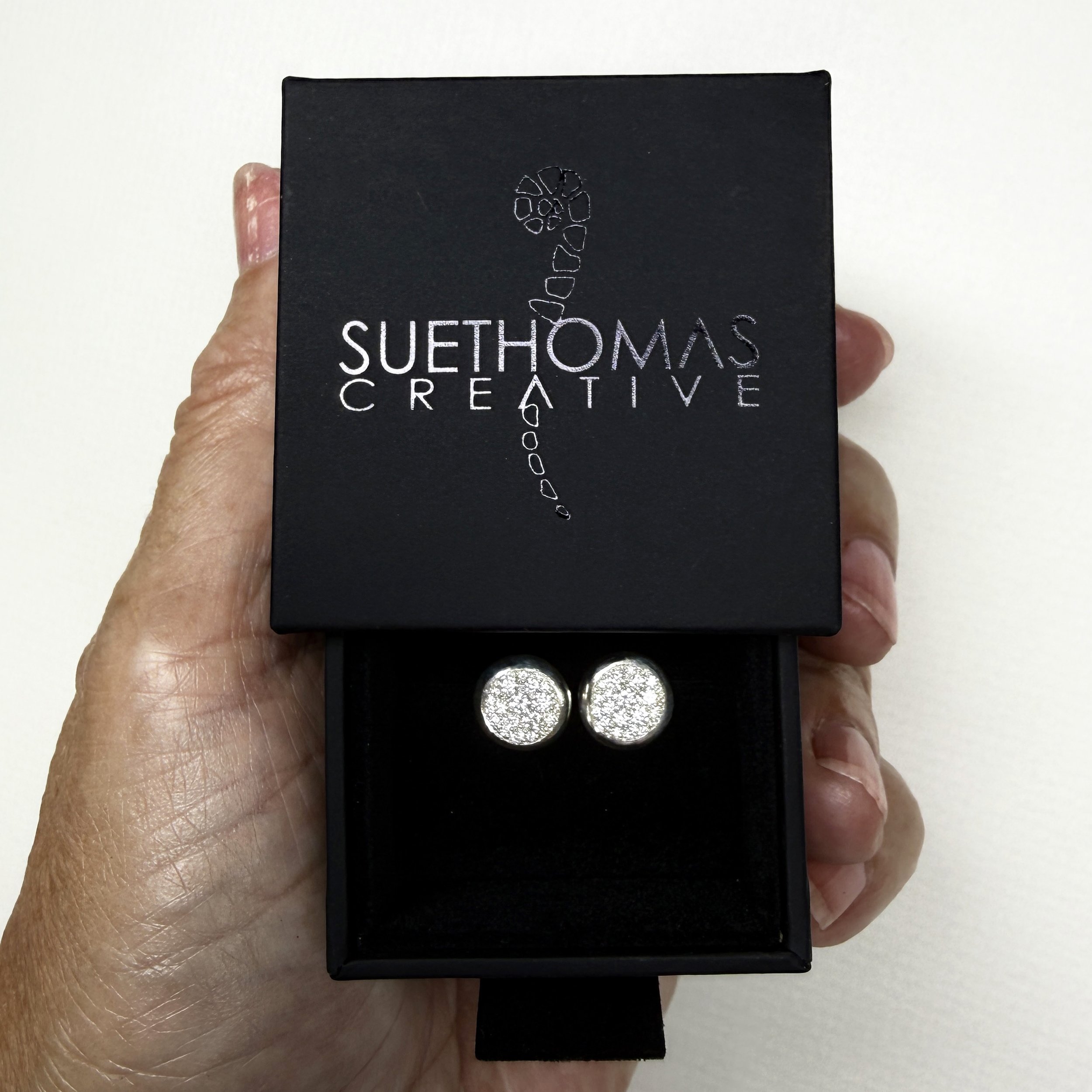 serti neige studs in box.jpg