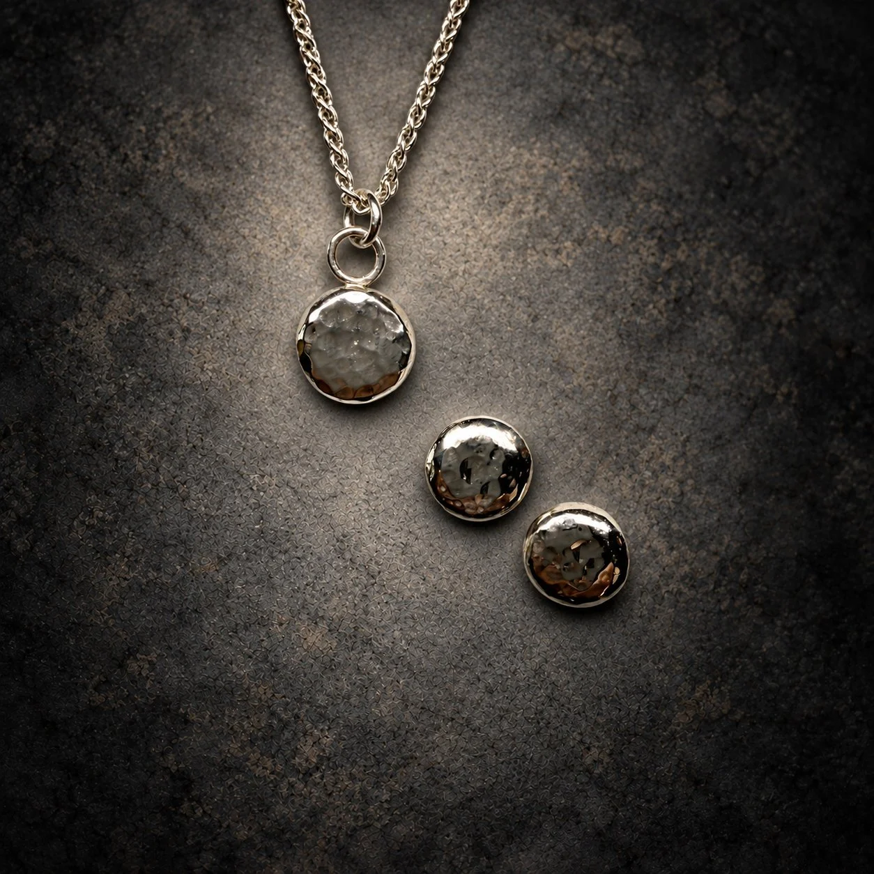 Front Hammered Silver Jewelry on Charcoal Stone.jpg