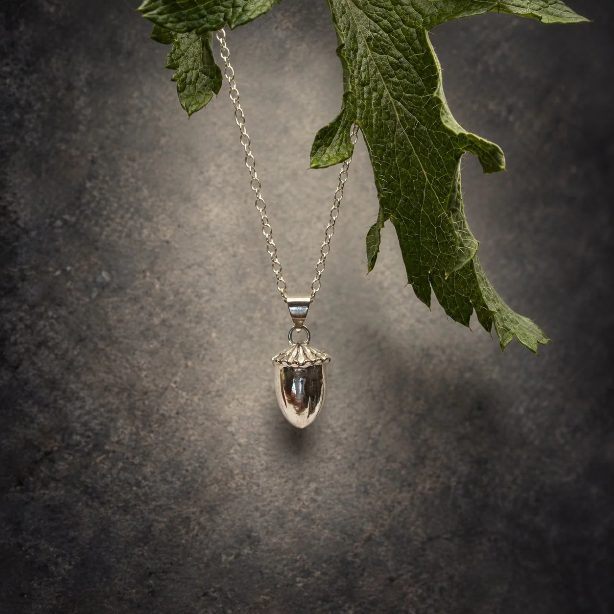Sterling silver poppy pod necklace with natural poppy leaf