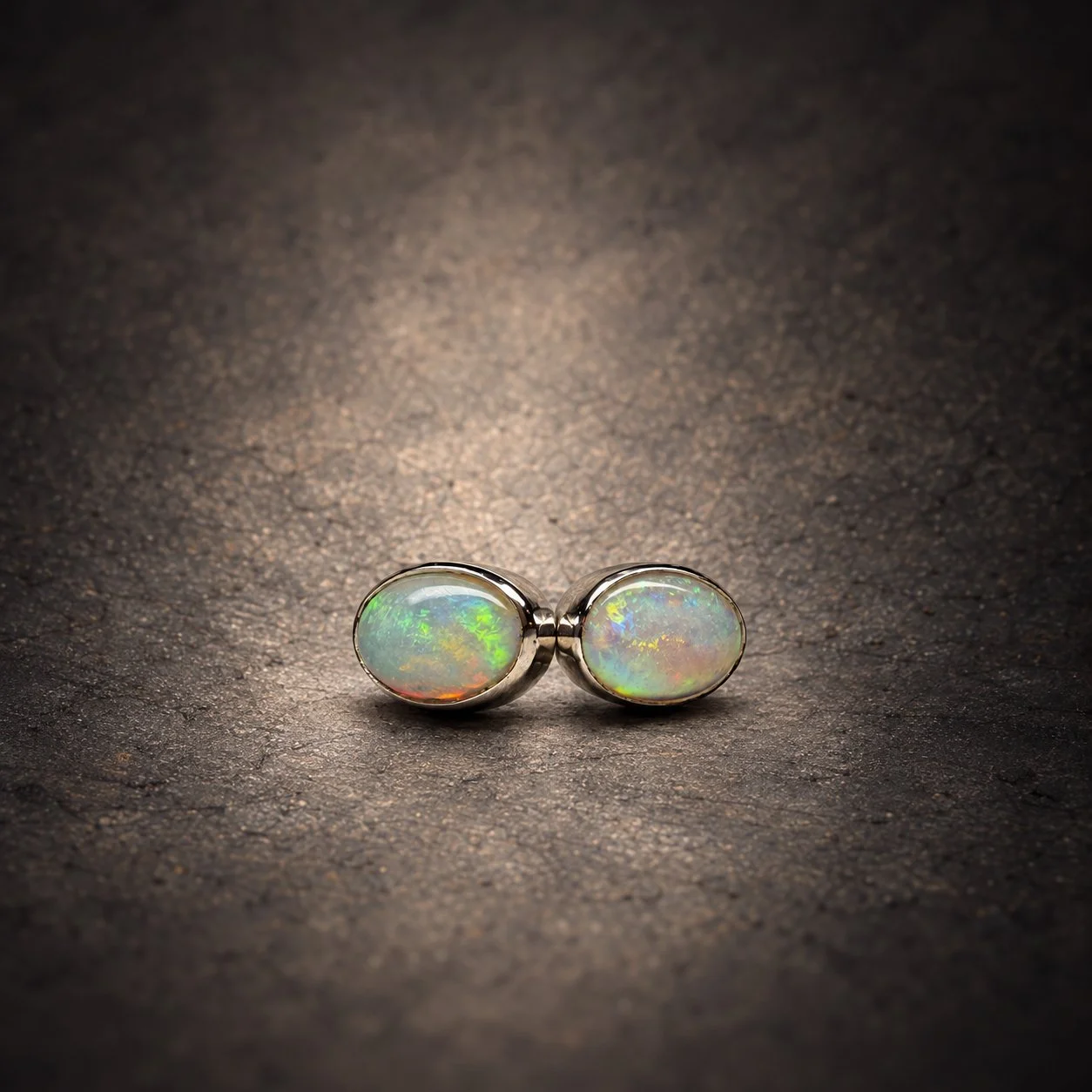 Oval opal silver stud earrings, side by side