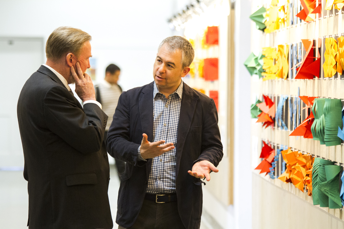 The Dean of the School of Architecture and Planning, Robert Shibley, FAIA, talks to Prof. Miguel Guitart at the exhibition Mapping Emotional Perceptions: Laboratory of Paper. May, 2016. Photograph by Mahan Mehrvarz for B/a+p.