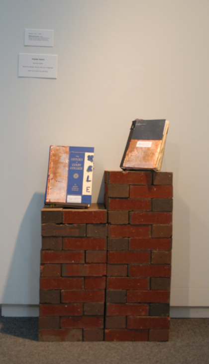 Altered books (Histories of Colby College) on brick plinth. Installation, 2007.