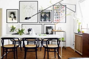 2 - wall of eclectic art in dining room