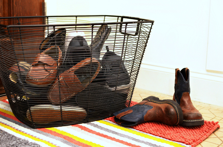 shoes get so messy at the front door and we often get lazy about putting them in a cupboard - what about a basket? resolve to always put your shoes inside the basket for a much neater front hall