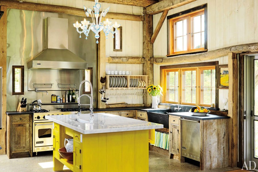 stylish-chandelier-and-steel-backsplash-behind-stove-also-yellow-island-cabinets-plus-black-sink-in-rustic-kitchen-idea.jpg