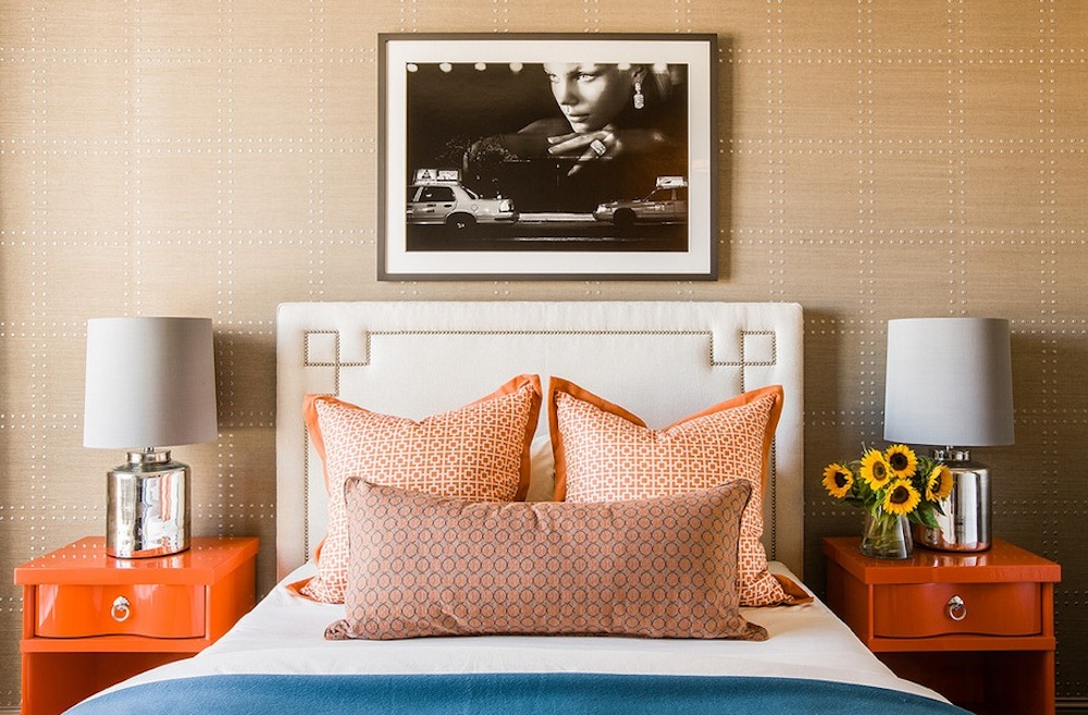 i love the way the little square shaped nail heads and wall treatment connect with the square orange nightstands - subtle but effective
