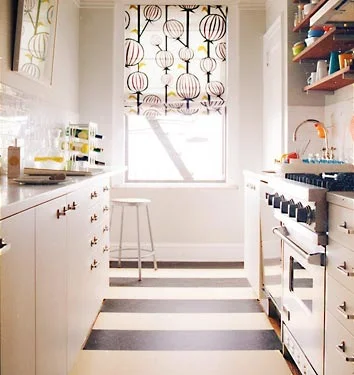 the striped floor is subtlely repeated in the stripe in the fabric