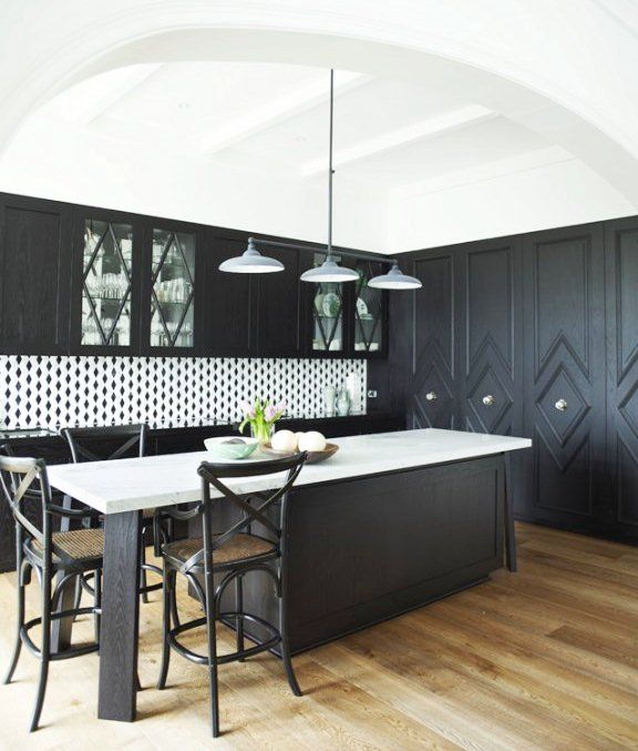 the diamond pattern is repeated on the wall of built-ins, the glass fronted cabinets and even in the backsplash