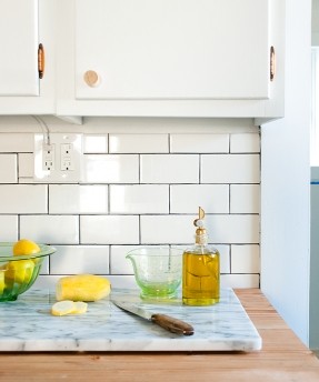 Buy a small piece of marble to use as a cutting board - it adds class and updates an old counter. Crate & Barrel has some really nice options.