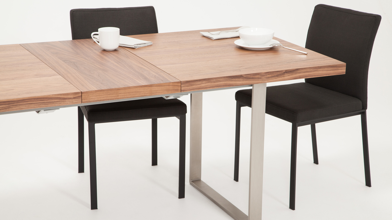 The Hatch dining table from EQ3 has a self storing leaf and a gorgeous walnut finish.