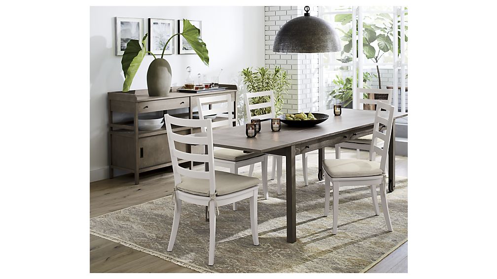  The Brookline table from Crate &amp; Barrel has storage drawers and a bit of an industrial feel with the wheels on one side of the table. Its 36" width is great for narrower spaces. 