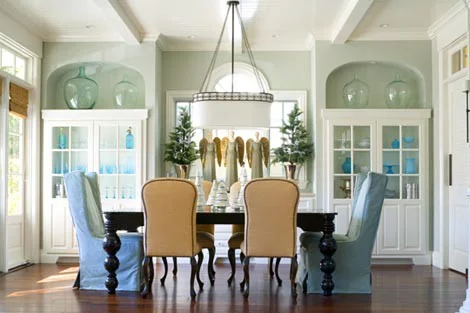 mismatched chairs around a dining table — toronto designers