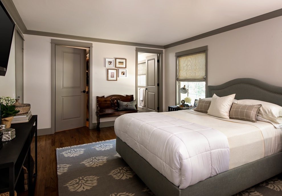 White-walls-dark-trim-bedroom-transitional-with-restored-trunk-white-bedding-wood-floors.jpg