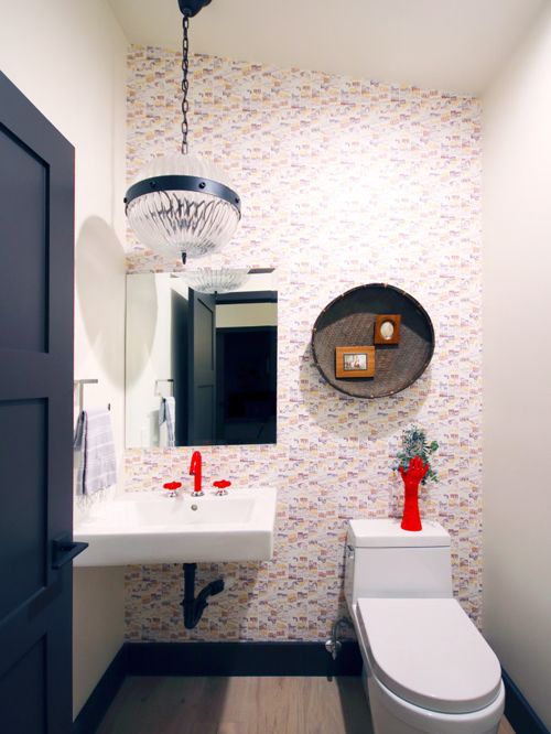 A dramatic light fixture can be part of a series of beautiful things in a powder room - here it looks great coupled with a red faucet!