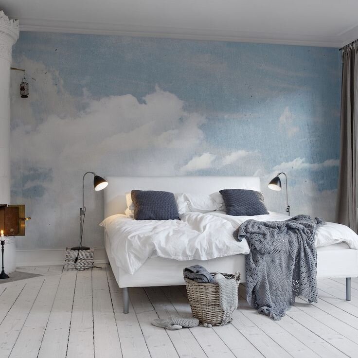 Blue-and-white-cloud-wallpaper-behind-a-bed.jpg